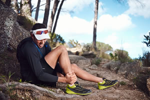 Photo of man with ankle injury hiking.